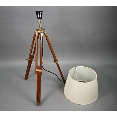 80 - A mid-20th century wooden and brass telescopic tripod converted to a table lamp, with an off-white c... 