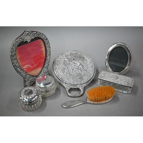 88 - A late Victorian silver hand-mirror, London 1899, to/w a heart-shaped easel photograph frame, Birmin... 