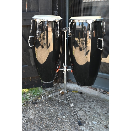 90 - A good pair of conga drums, with central stand, each drum 75 cm high