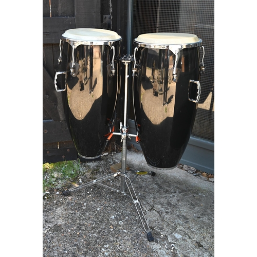 90 - A good pair of conga drums, with central stand, each drum 75 cm high