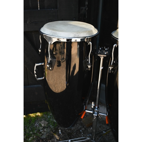 90 - A good pair of conga drums, with central stand, each drum 75 cm high