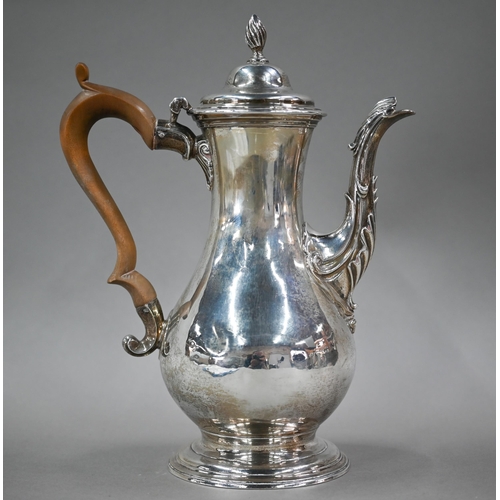 93 - A George III silver pear-shaped coffee pot, the domed lid with writhen flame finial, with scrolling ... 