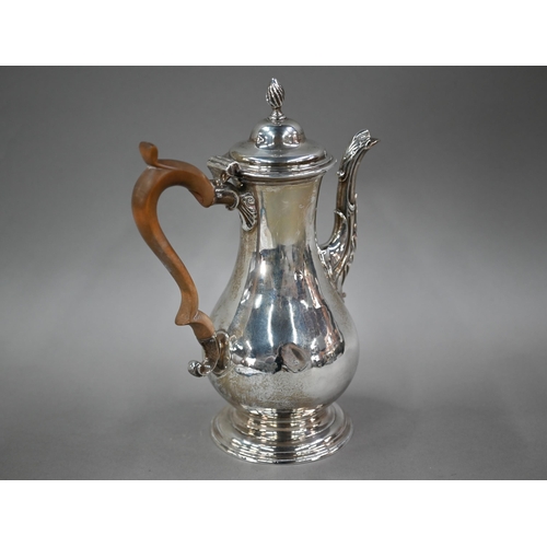 93 - A George III silver pear-shaped coffee pot, the domed lid with writhen flame finial, with scrolling ... 