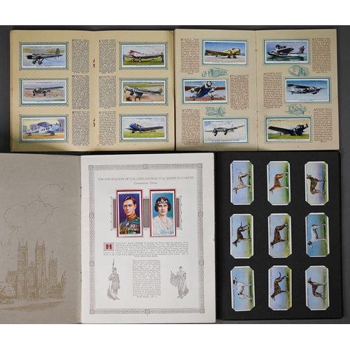 1053 - A quantity of cigarette cards loose, in albums and one frame including Godfrey Phillips, Players, Wi... 