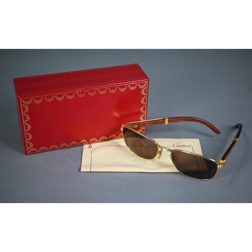 1083 - A boxed pair of Cartier C Decor 140B sunglasses with babinga wood arms (little used)