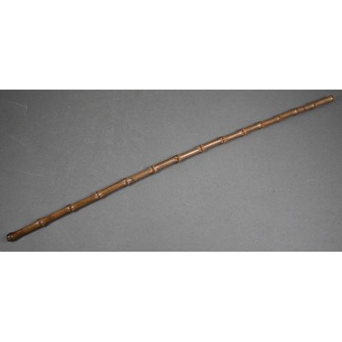 1128 - A Japanese Bokken (wooden practice katana sword), 101 cm to/w bamboo swagger stick (2)Purchasers mus... 