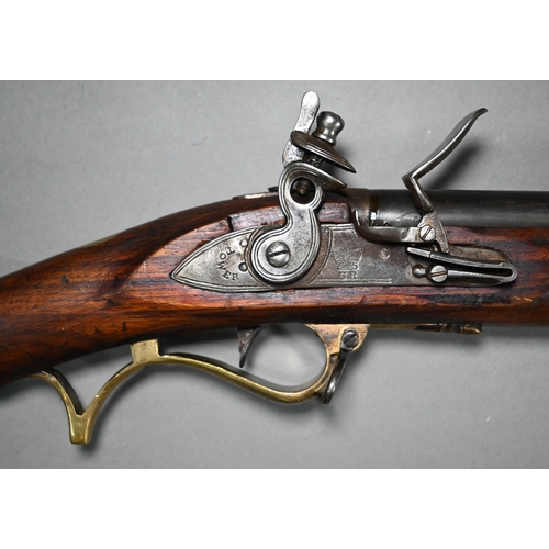 1131 - A replica Georgian flintlock 'Brown Bess' musket, the 78.5 cm barrel with bayonet mounting-clip, on ... 