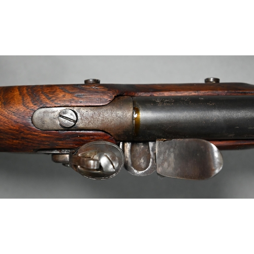 1131 - A replica Georgian flintlock 'Brown Bess' musket, the 78.5 cm barrel with bayonet mounting-clip, on ... 