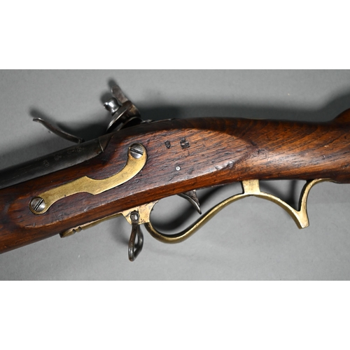 1131 - A replica Georgian flintlock 'Brown Bess' musket, the 78.5 cm barrel with bayonet mounting-clip, on ... 