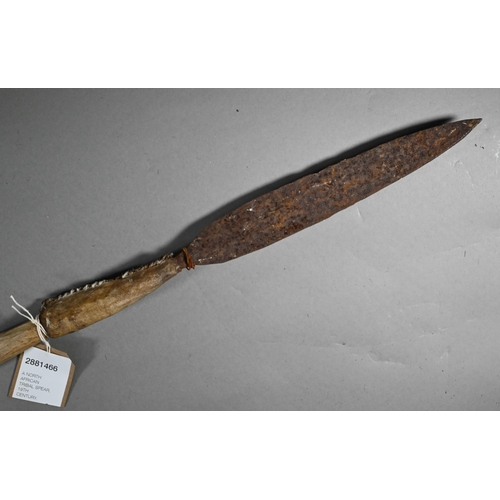 1132 - An antique North African tribal spear, the iron tip with stitched hide handlePurchasers must be 18 a... 