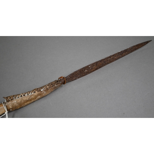 1132 - An antique North African tribal spear, the iron tip with stitched hide handlePurchasers must be 18 a... 