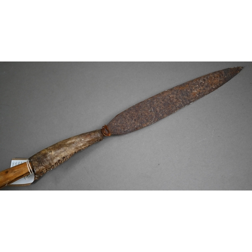 1132 - An antique North African tribal spear, the iron tip with stitched hide handlePurchasers must be 18 a... 