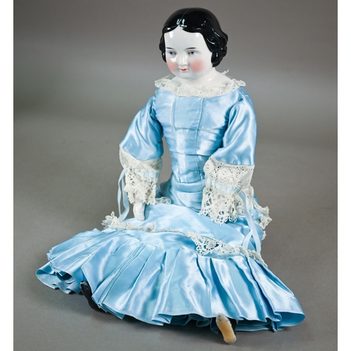 1158 - A Victorian china-headed girl doll, on stuffed fabric body with china lower limbs (one leg restored)... 