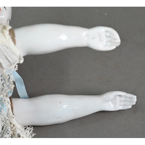 1158 - A Victorian china-headed girl doll, on stuffed fabric body with china lower limbs (one leg restored)... 