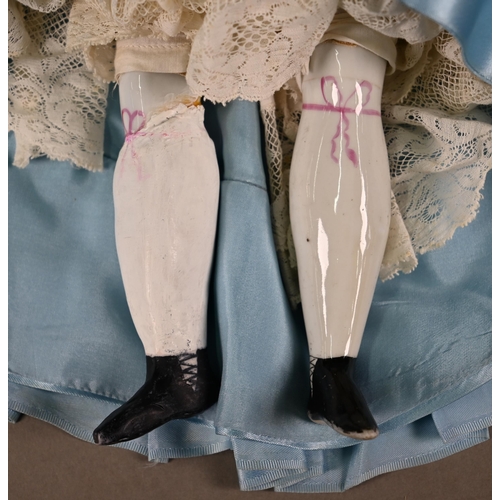 1158 - A Victorian china-headed girl doll, on stuffed fabric body with china lower limbs (one leg restored)... 