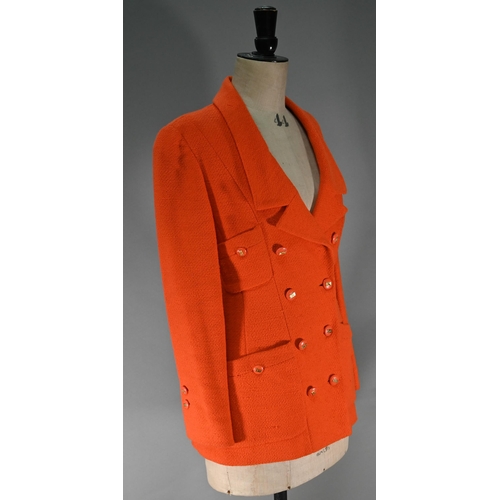 1187 - A Chanel Boutique fitted long-line jacket in orange boucle wool, double breasted with four pockets a... 