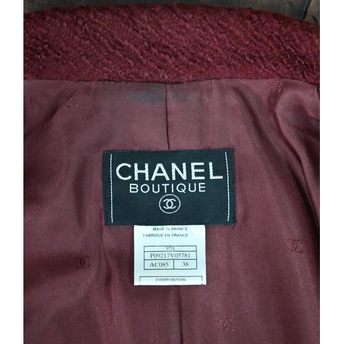 1189 - A Chanel Boutique fitted burgundy jacket in wool and mohair, long line, single breasted with two low... 