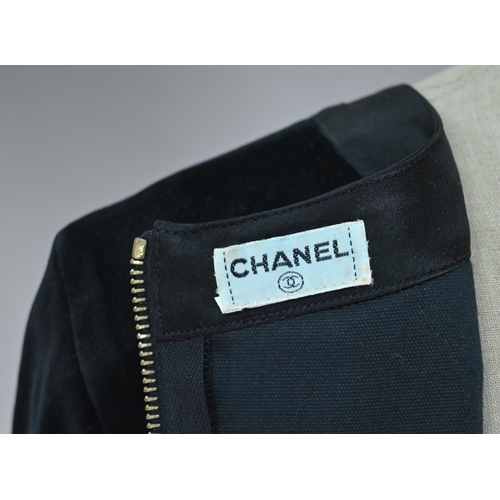 1191 - Chanel - A black velvet fitted evening top with Chanel motif zip fastening to length of back and cuf... 