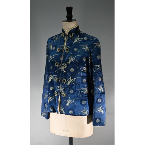 1192 - A Chinese navy blue silk mandarin-style jacket with shaped collar and buttons to front, sheepskin-ty... 