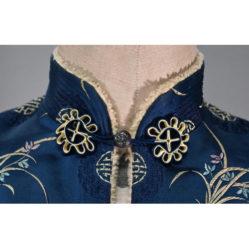 1192 - A Chinese navy blue silk mandarin-style jacket with shaped collar and buttons to front, sheepskin-ty... 