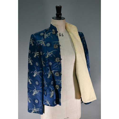 1192 - A Chinese navy blue silk mandarin-style jacket with shaped collar and buttons to front, sheepskin-ty... 