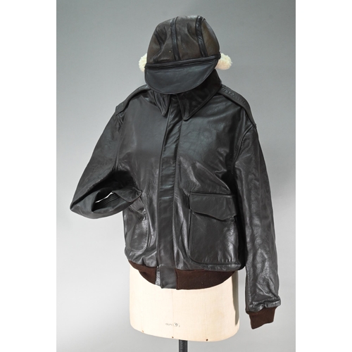 1200 - Film interest - a dark brown leather flying jacket size L and matching cap with sheepskin lining, fr... 