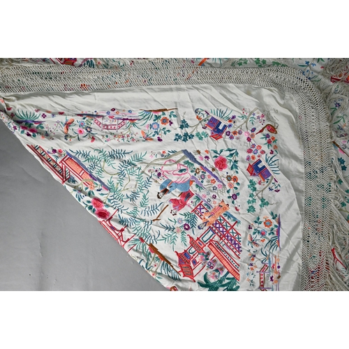 1202 - A Chinese sik piano shawl, the cream ground profusely embroidered with figures, Pagoda scenes and fa... 