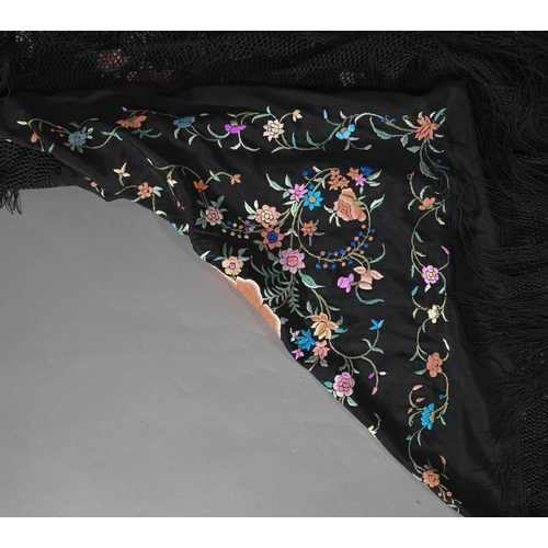 1204 - A Chinese silk fringed piano shawl, the black ground richly decorated with flowers and foliage, 130 ... 