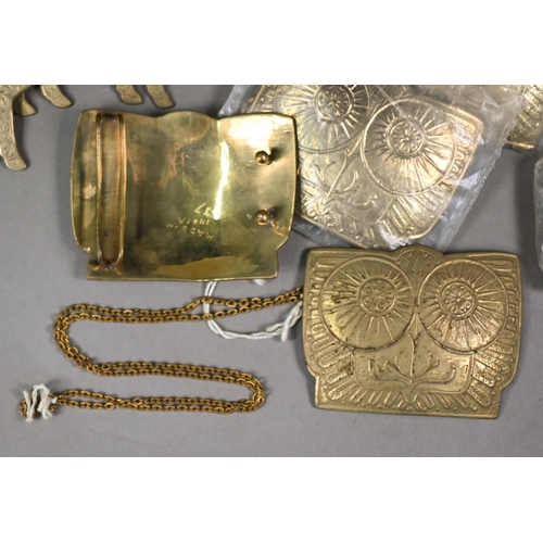 1205 - A collection of twenty Indian cast brass buckles, some in the form of standing rams, some with chase... 