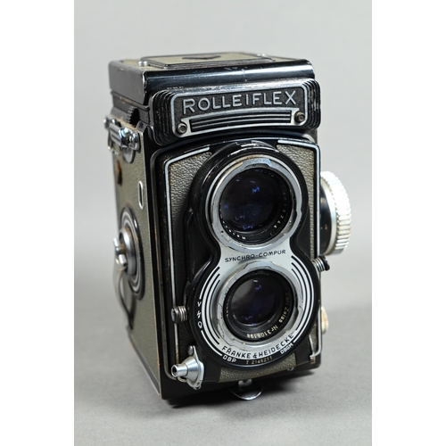 1223 - A Rolleiflex twin-lens reflex camera with Synchro-Compur lens, in leather case with trigger-handle, ... 