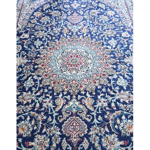 804 - A central Persian part silk Nain carpet, the field centred by a medallion with flowering vines, on b... 