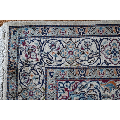 804 - A central Persian part silk Nain carpet, the field centred by a medallion with flowering vines, on b... 