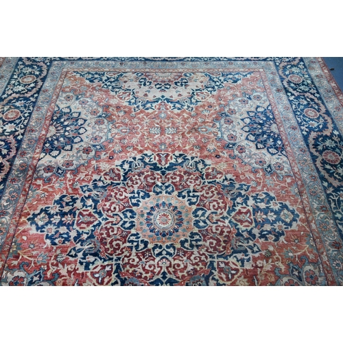 806 - An Indo-Persian Tabriz carpet, the blue/coral ground centred by a floral medallion 356cm x 269cm