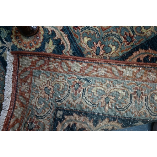 806 - An Indo-Persian Tabriz carpet, the blue/coral ground centred by a floral medallion 356cm x 269cm