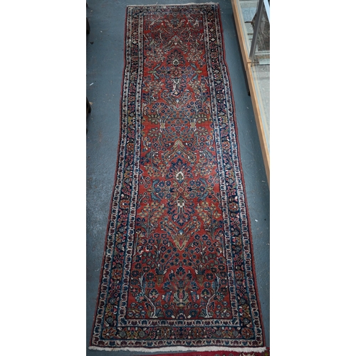 809 - An old Persian Sarouk runner, the stylised floral vine design on pale red ground, 358 cm x 107 cmPro... 