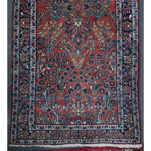 809 - An old Persian Sarouk runner, the stylised floral vine design on pale red ground, 358 cm x 107 cmPro... 