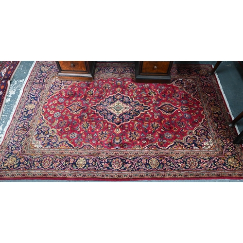 810 - An old Persian Kashan rug, the red ground centred by a floral medallion, 215 cm x 135 cm