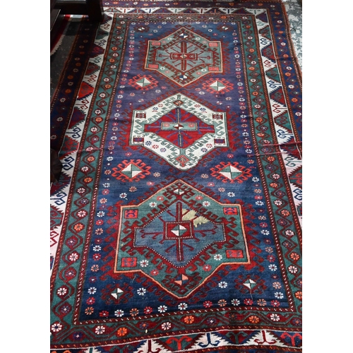 811 - An old Caucasian kelleh carpet, the blue ground with multi-coloured lozenge design, 326 cm x 178 cm