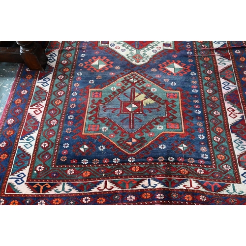 811 - An old Caucasian kelleh carpet, the blue ground with multi-coloured lozenge design, 326 cm x 178 cm