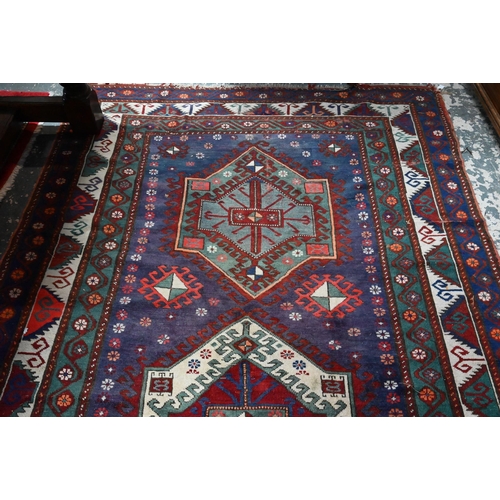 811 - An old Caucasian kelleh carpet, the blue ground with multi-coloured lozenge design, 326 cm x 178 cm