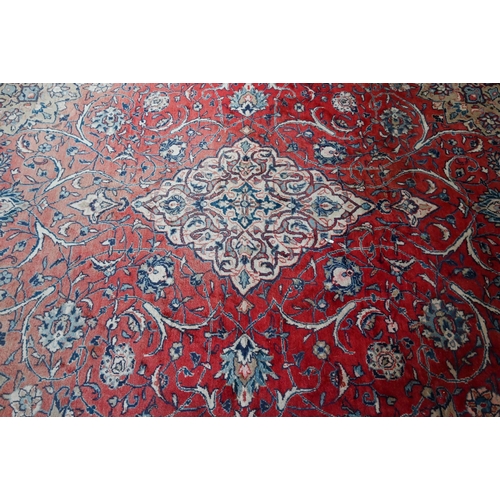 812 - An old Persian mahal carpet, the pale red ground centred by a stylised floral medallion, 377 cm x 27... 