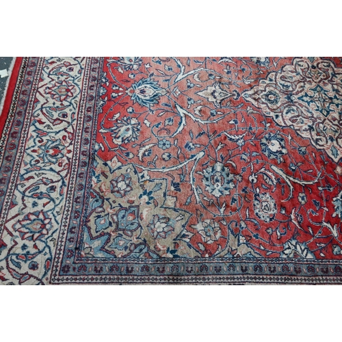 812 - An old Persian mahal carpet, the pale red ground centred by a stylised floral medallion, 377 cm x 27... 