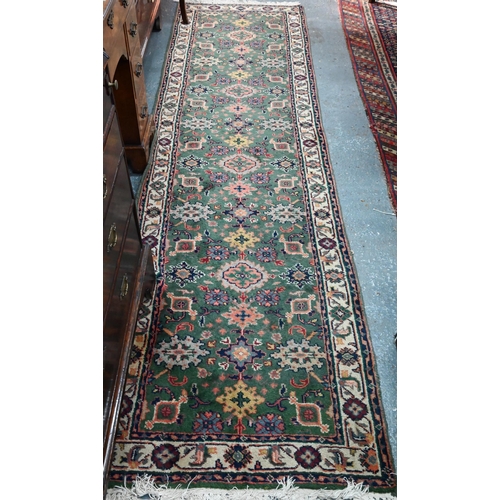 815 - An old Persian green ground runner, 292 cm x 76 cm