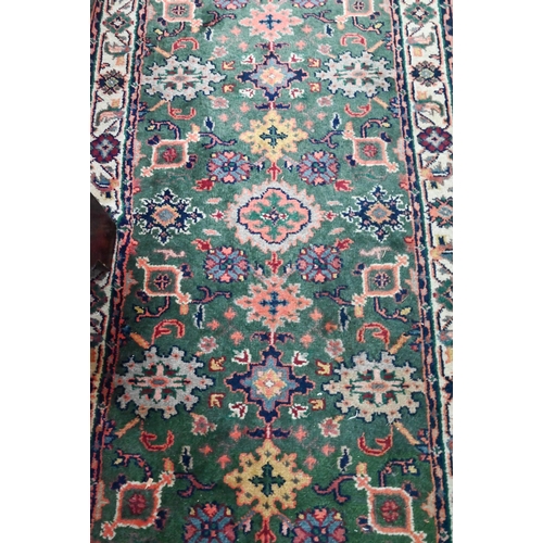 815 - An old Persian green ground runner, 292 cm x 76 cm