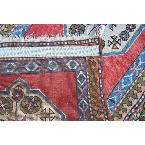 817 - A Turkish Kazak design runner, the four diamond pole design on red ground, 323 cm x 78 cm