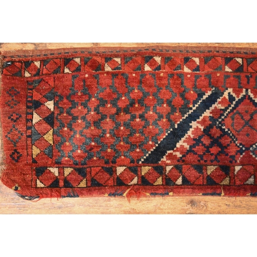 820 - An antique Afghan Turkoman red ground geometric design bag face, 144 cm x 47 cm