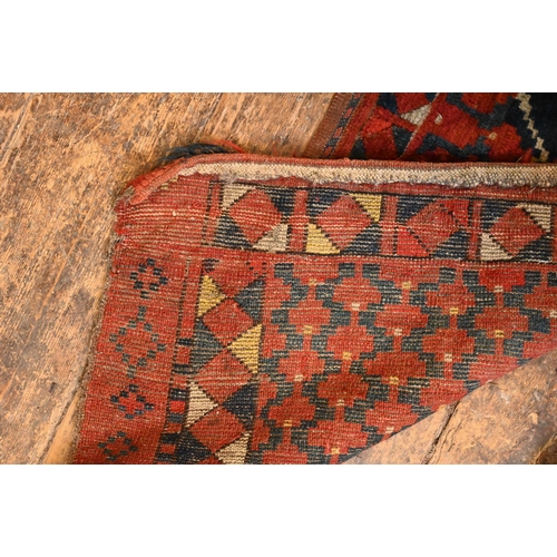 820 - An antique Afghan Turkoman red ground geometric design bag face, 144 cm x 47 cm