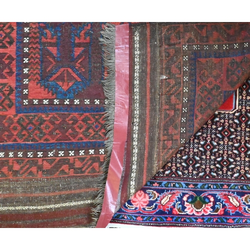 822 - An antique Belouch rug, the red-brown ground with narrow blue bands and wide kelim ends, 202 cm x 10... 