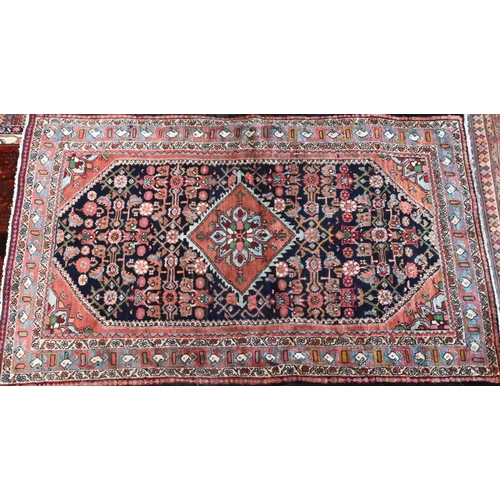 825 - An old North West Persian Mahal rug, the blue ground with centre medallion in red, 200 cm x 125 cm