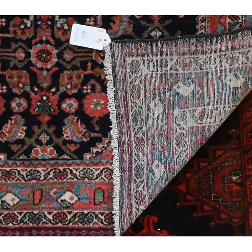 825 - An old North West Persian Mahal rug, the blue ground with centre medallion in red, 200 cm x 125 cm